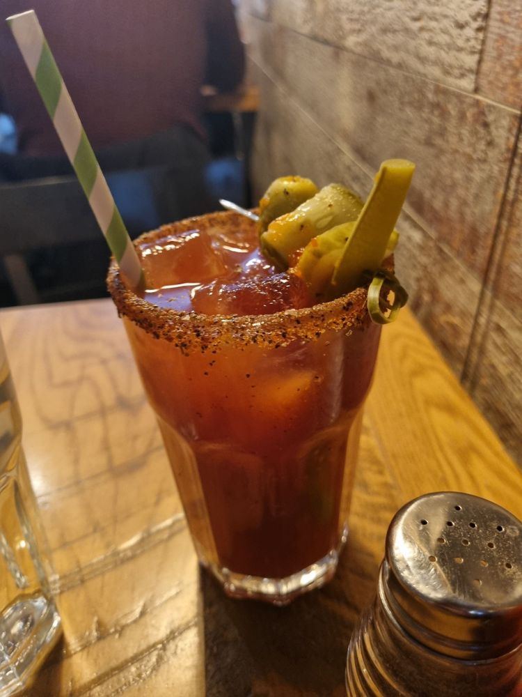 A Caesar with a spiced rim and pickled garnish